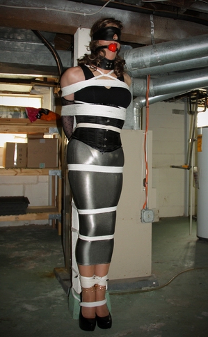 sexy Paige Andrews all roped up in tight bondage tied up and left in a perverts basement blindfolded and ball gagged